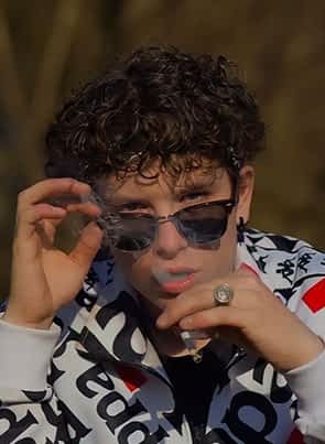 Gioele pornstar smoking while moving his sunglasses down and posing for the camera.