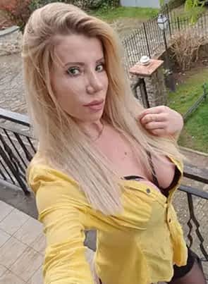 Lara De Santis pornstar in yellow t-shirt and black garter straps on her butt and thighs.