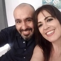 Nico pornstar taking a selfie with his wife Montse Swinger. Both as smiling at the camera sitting down on a couch.
