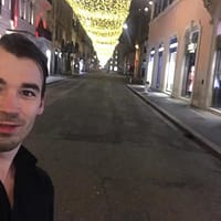 Maestro Max porn star at Covent Garden at night wearing black shirt and smiling while taking a selfie.