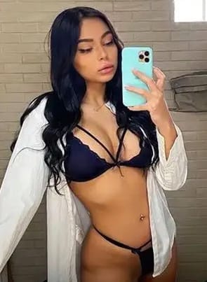 Sofia Pavlidi selfie in the bathroom with blue lingerie and white t-shirt.