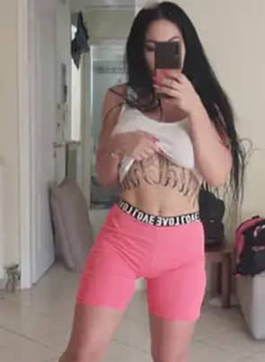 Alice Alisaki taking a selfie in her sportswear, lifting her shirt to show her underboob tattoo.
